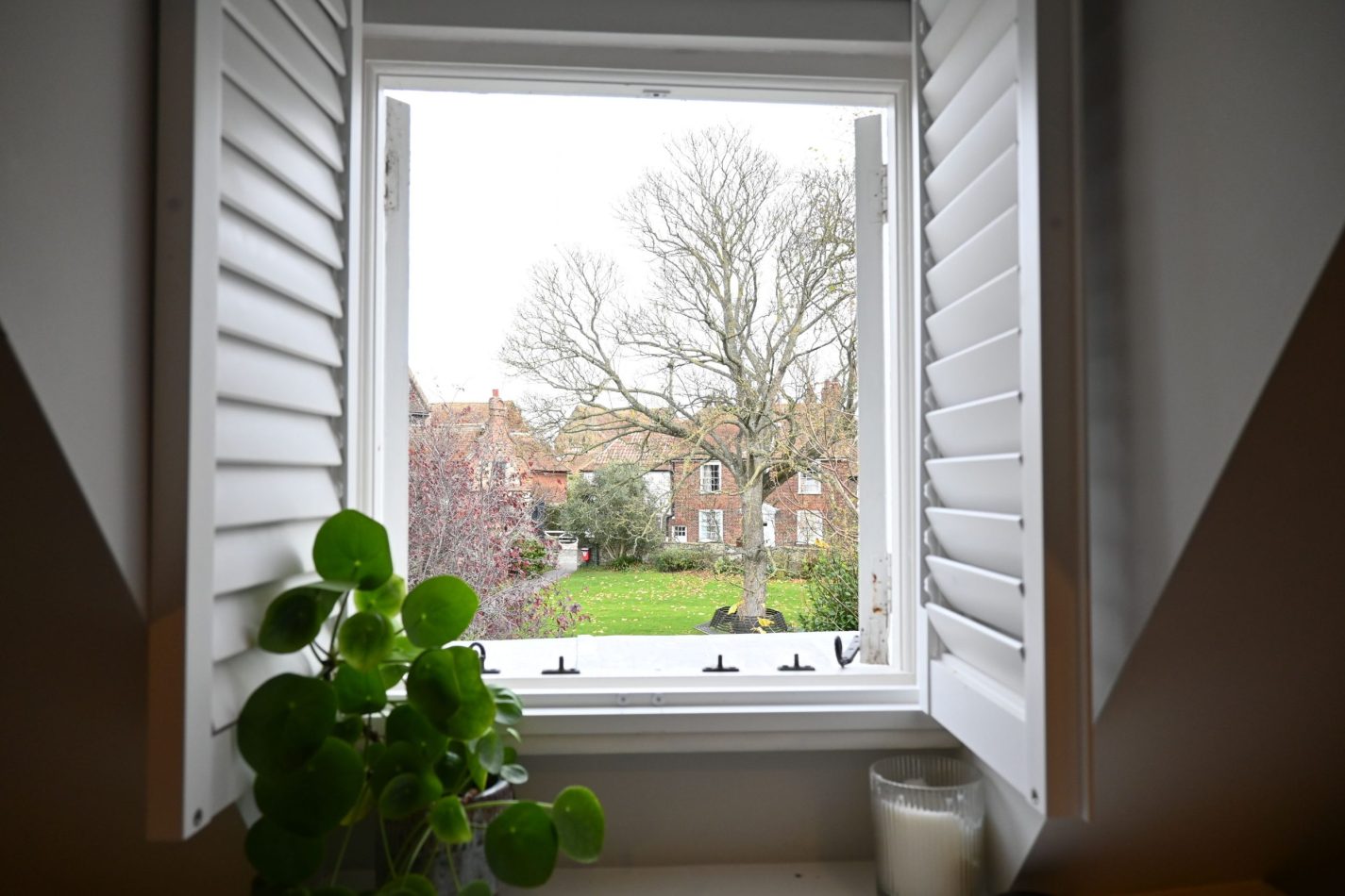 From your upstairs window, enjoy peaceful views across the gardens below—an ever-changing, leafy backdrop that adds calm to your stay in the heart of Sandwich, Kent.