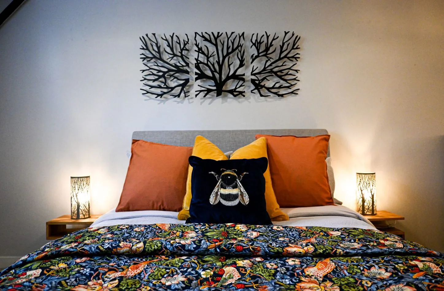Your spacious king bedroom blends rich blues and warm yellow and orange accents to create a calming retreat, with garden and church views offering a peaceful backdrop to slow mornings and restful nights.
