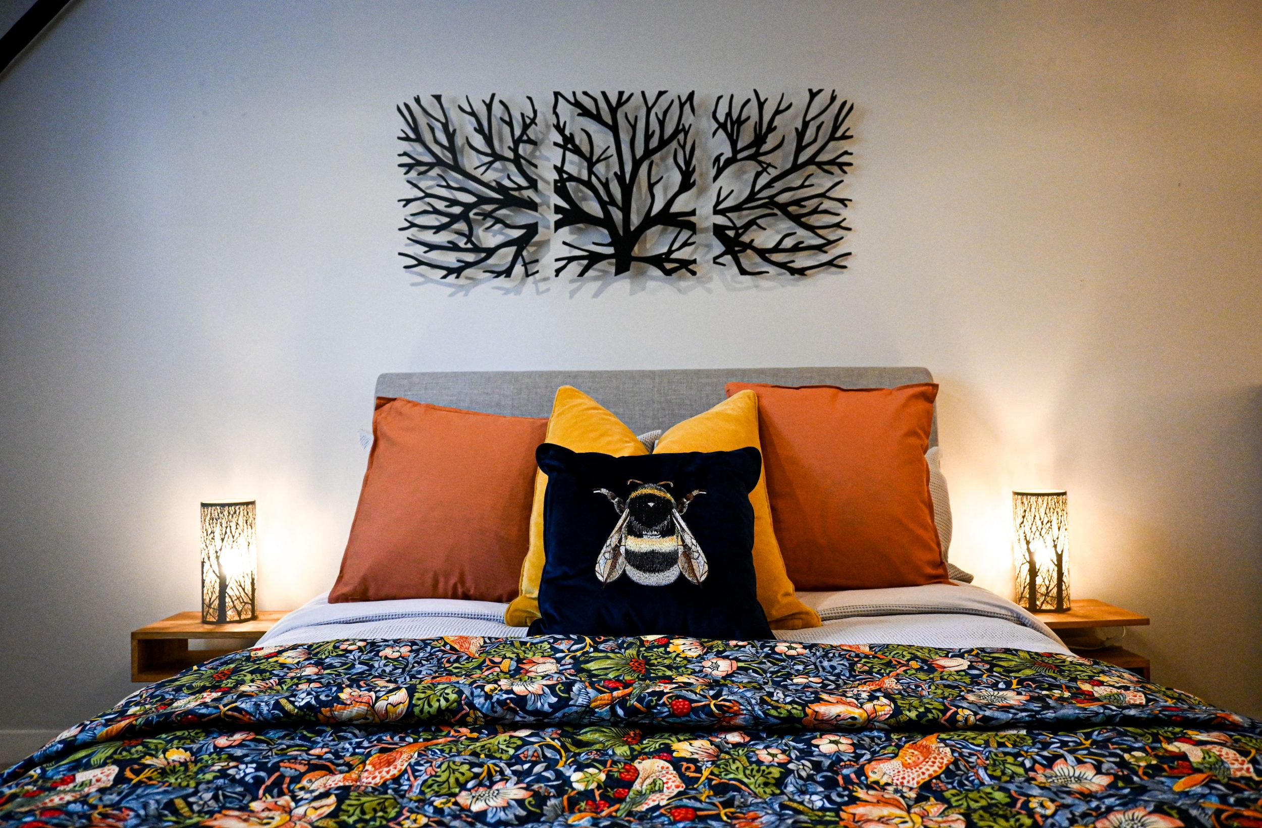 Your spacious king bedroom blends rich blues and warm yellow and orange accents to create a calming retreat, with garden and church views offering a peaceful backdrop to slow mornings and restful nights.