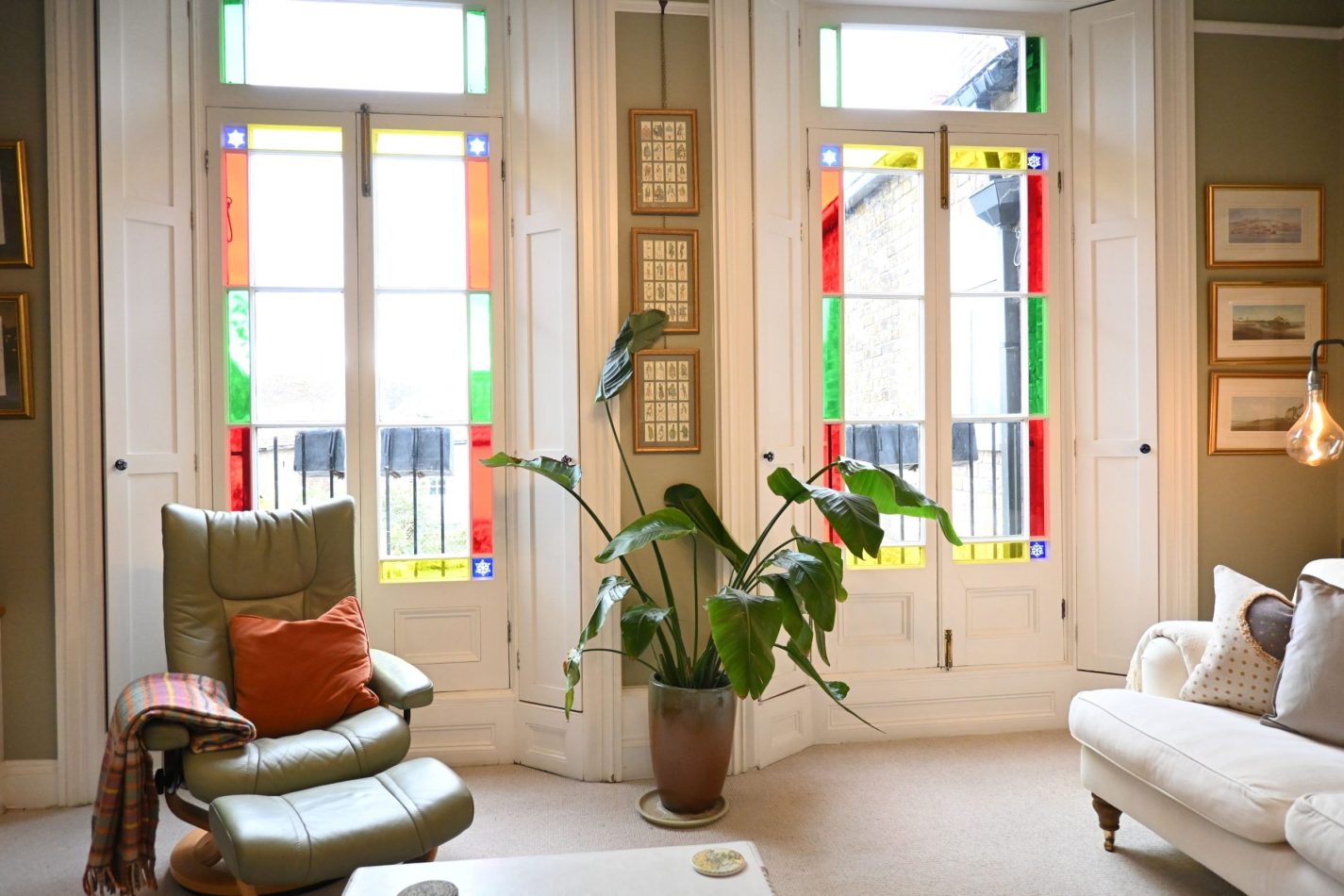 Your lounge is framed by beautiful stained glass floor-to-ceiling windows, flooding the space with light and adding character to your central Sandwich apartment—perfect for relaxing after coastal days or nearby golf.