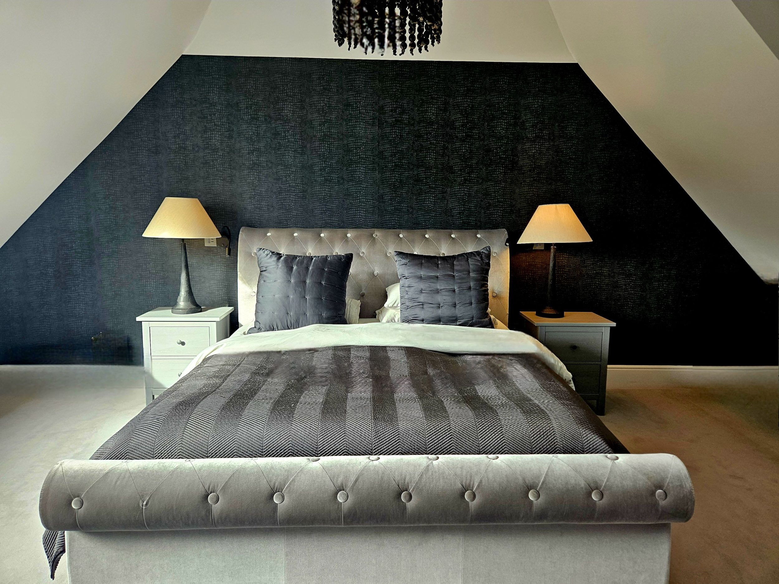 Unwind in the spacious master suite, styled in cool black, white and grey tones for a sleek, modern feel. With a private ensuite and plenty of room to relax, itâ€™s a luxurious retreat within this Kent holiday home.