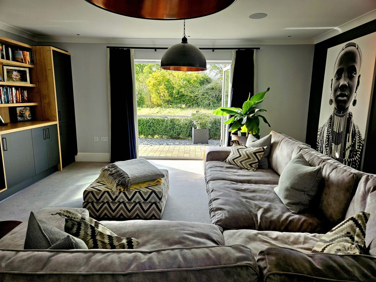 Unwind in the snug cinema room with patio doors open to the garden, blending cosy comfort with fresh air. Perfect for movie nights, relaxed evenings and luxury holiday stays in Kent.