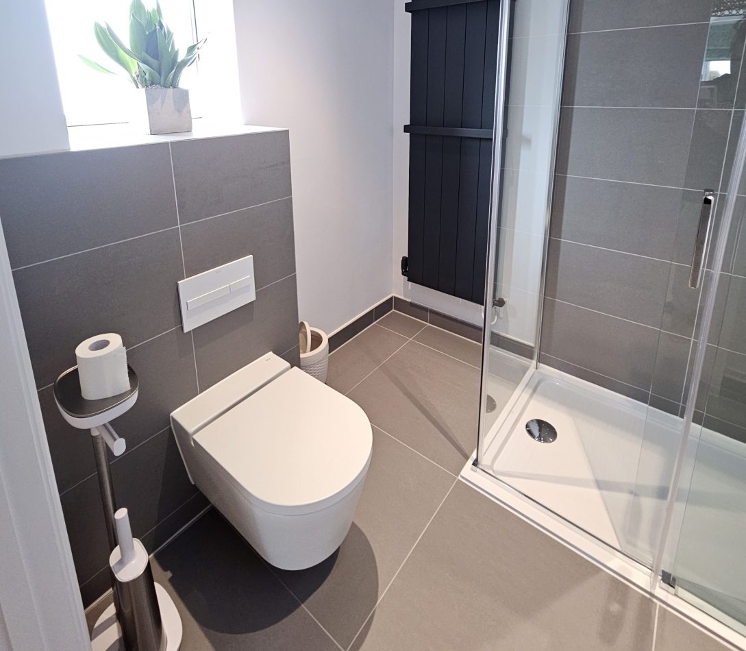 Refresh in the spacious ensuite featuring a large walk-in shower, designed for comfort and style. A clean, modern space perfect for starting your day or unwinding in this luxury Kent holiday home.