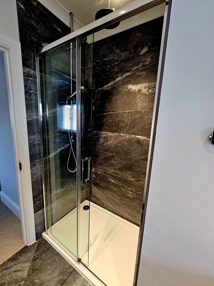 A spacious family bathroom with both bath and shower, perfect for busy mornings and relaxed evenings. Designed for comfort and convenience, ideal for family stays in this luxury Kent holiday home.