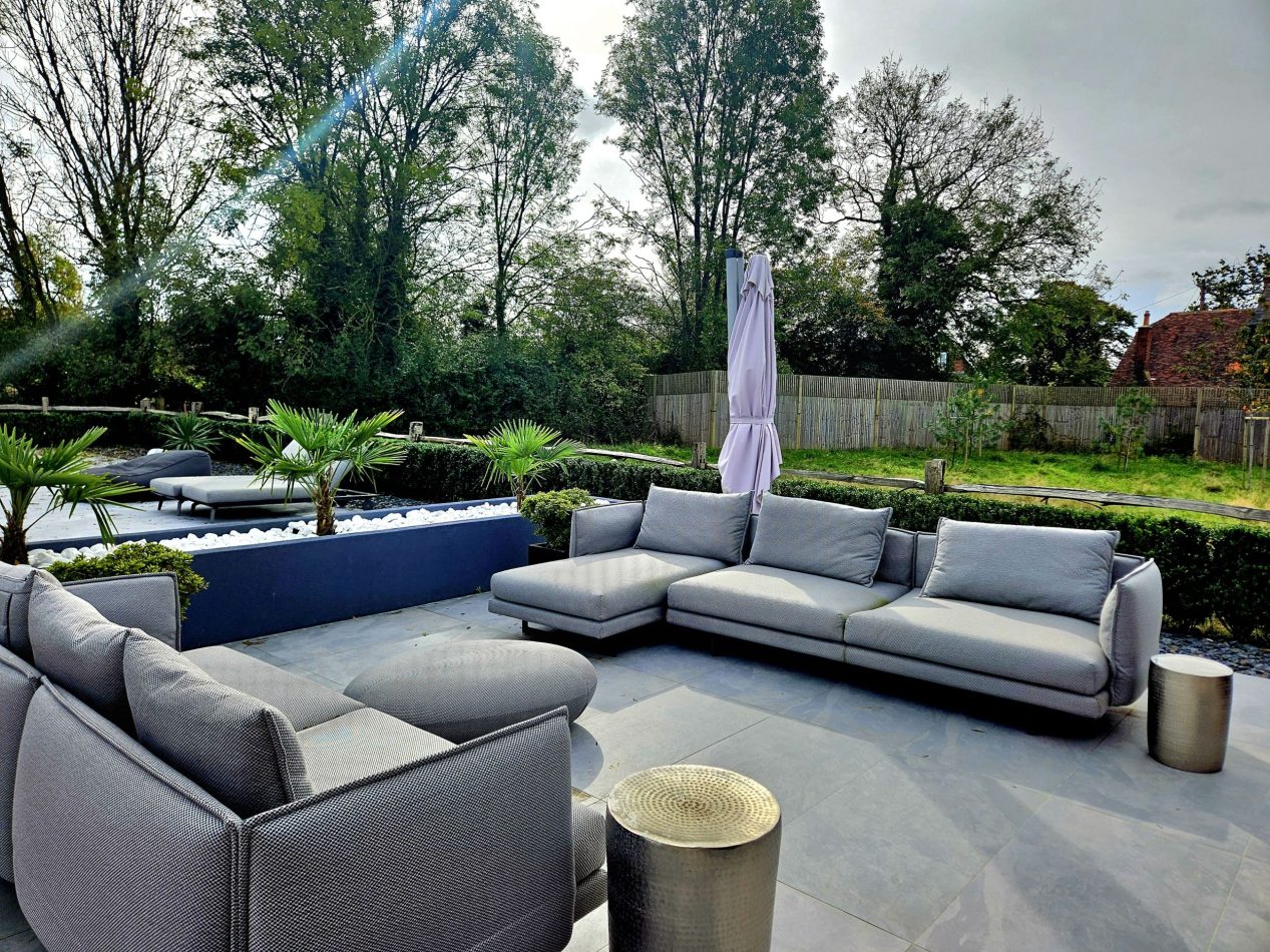 Unwind in the huge outdoor lounge area with stylish furniture, perfect for relaxing afternoons and sociable evenings. A standout alfresco space for entertaining and enjoying luxury stays in this Kent holiday home.
