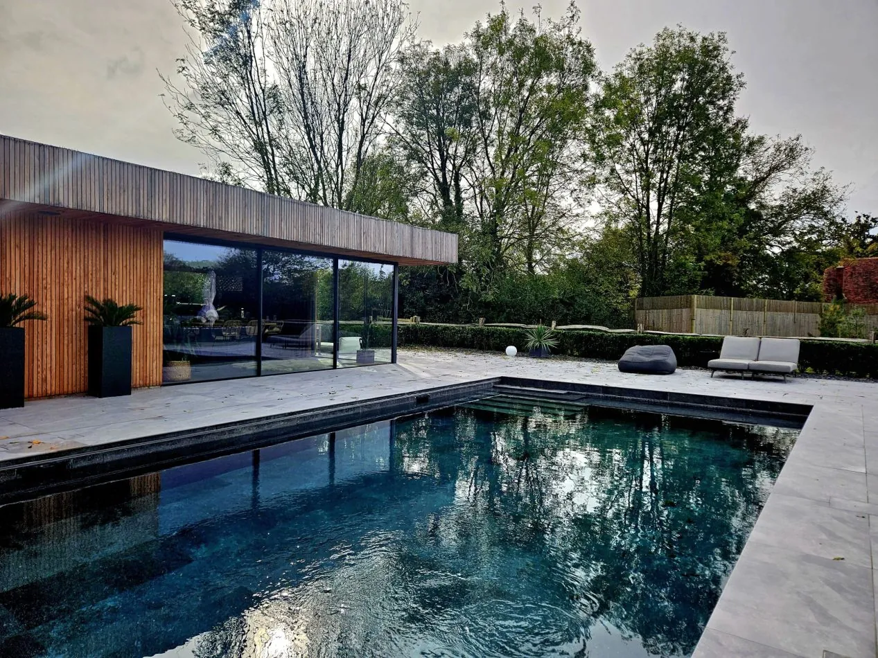Enjoy the outdoor heated pool with a stylish pool house, outdoor kitchen and lounge area, perfect for entertaining, al fresco dining and relaxed summer stays in this luxury Kent holiday home.