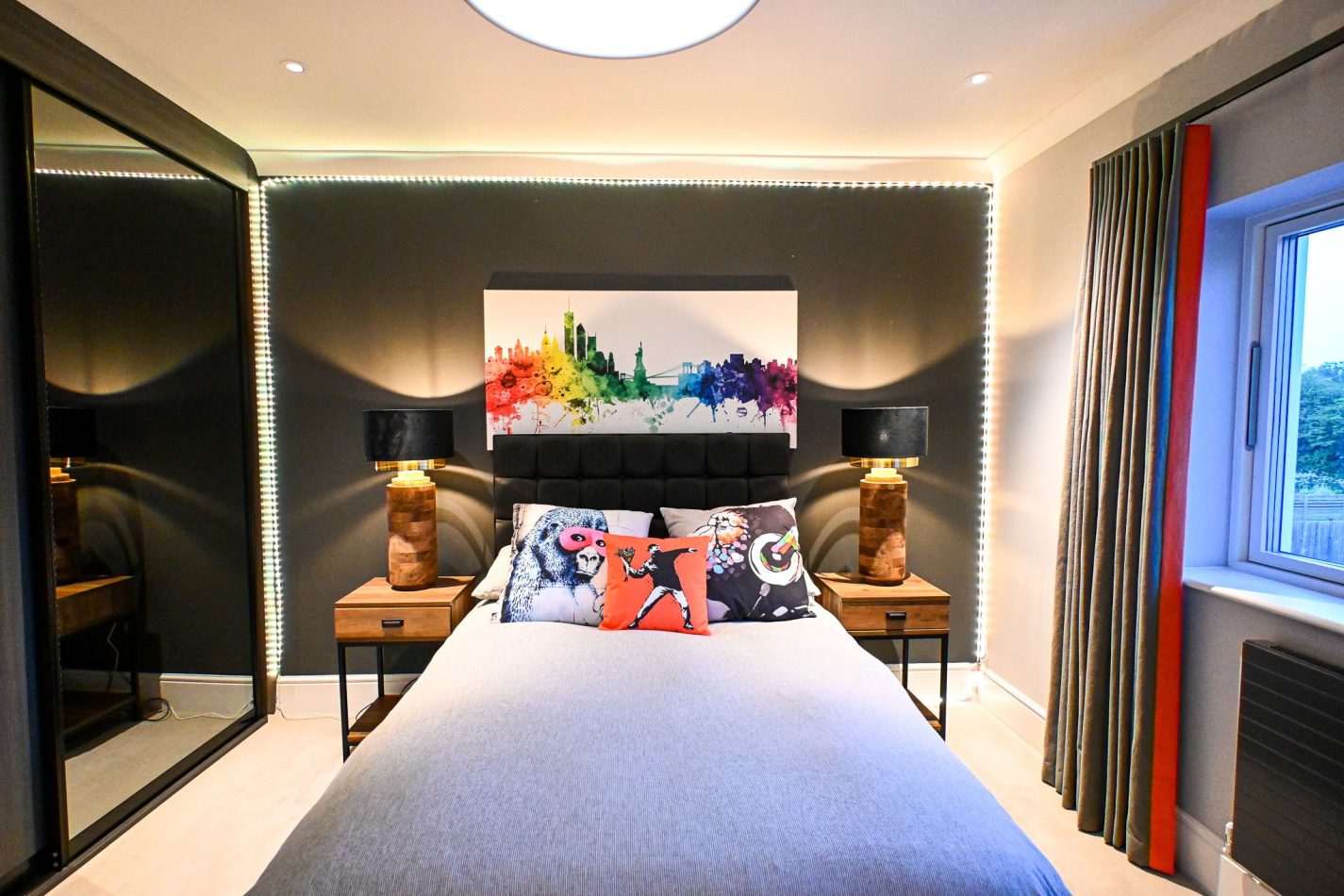 Relax in this colourful, stylish double bedroom, designed with bold tones and modern touches. A welcoming space perfect for restful nights and comfortable stays in this luxury Kent holiday home.