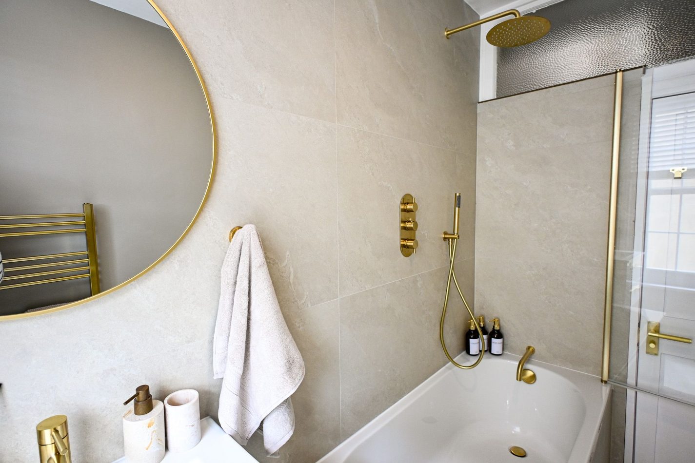 Whether you're enjoying a long soak after a day by the sea or getting ready for an evening in Ramsgate, this stylish family bathroom combines contemporary design, elegant gold accents and a full-size bath for ultimate comfort and relaxation.
