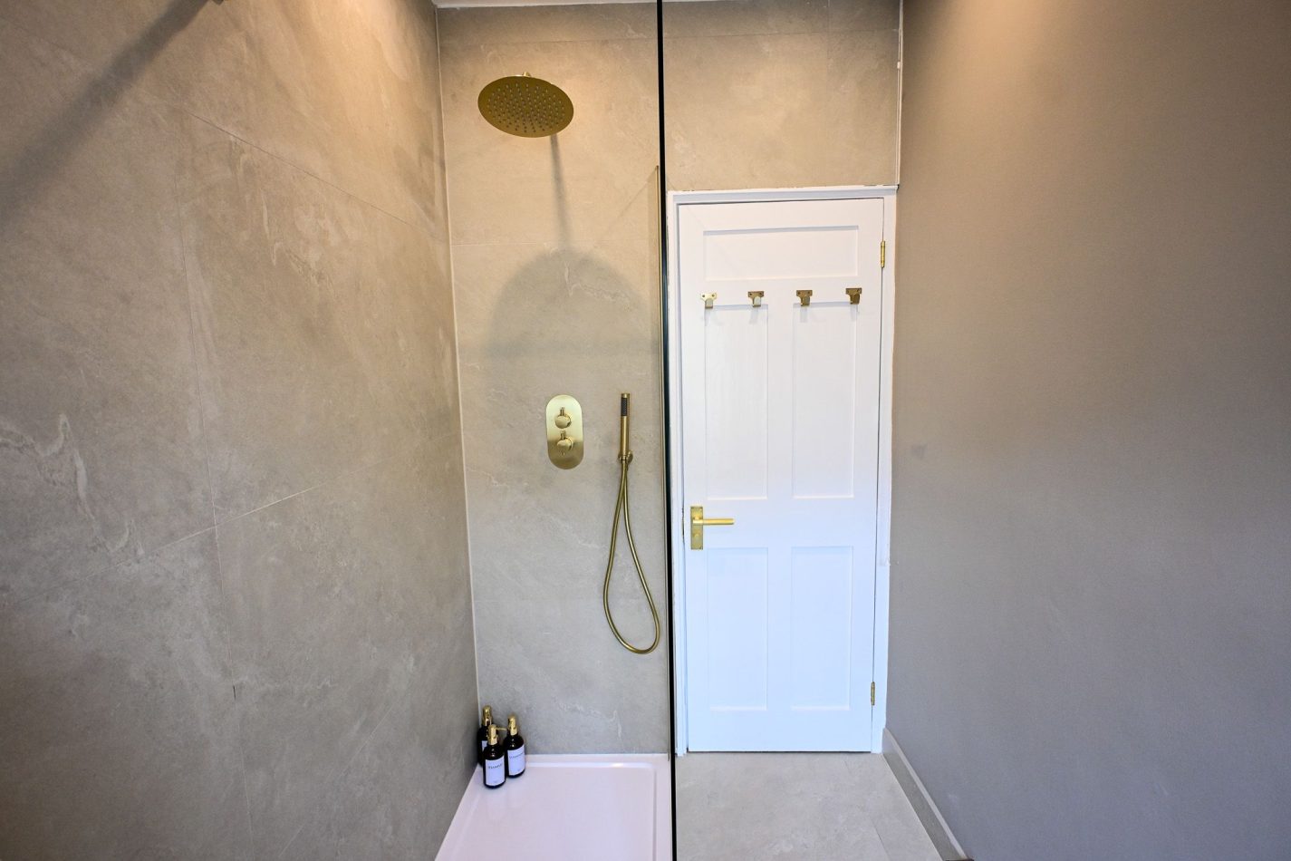 Refresh and recharge in this spacious walk-in shower, featuring contemporary finishes and a luxurious rainfall shower head. Thoughtfully designed for comfort and convenience, it's the perfect place to start your day or unwind after exploring Ramsgate's Ro