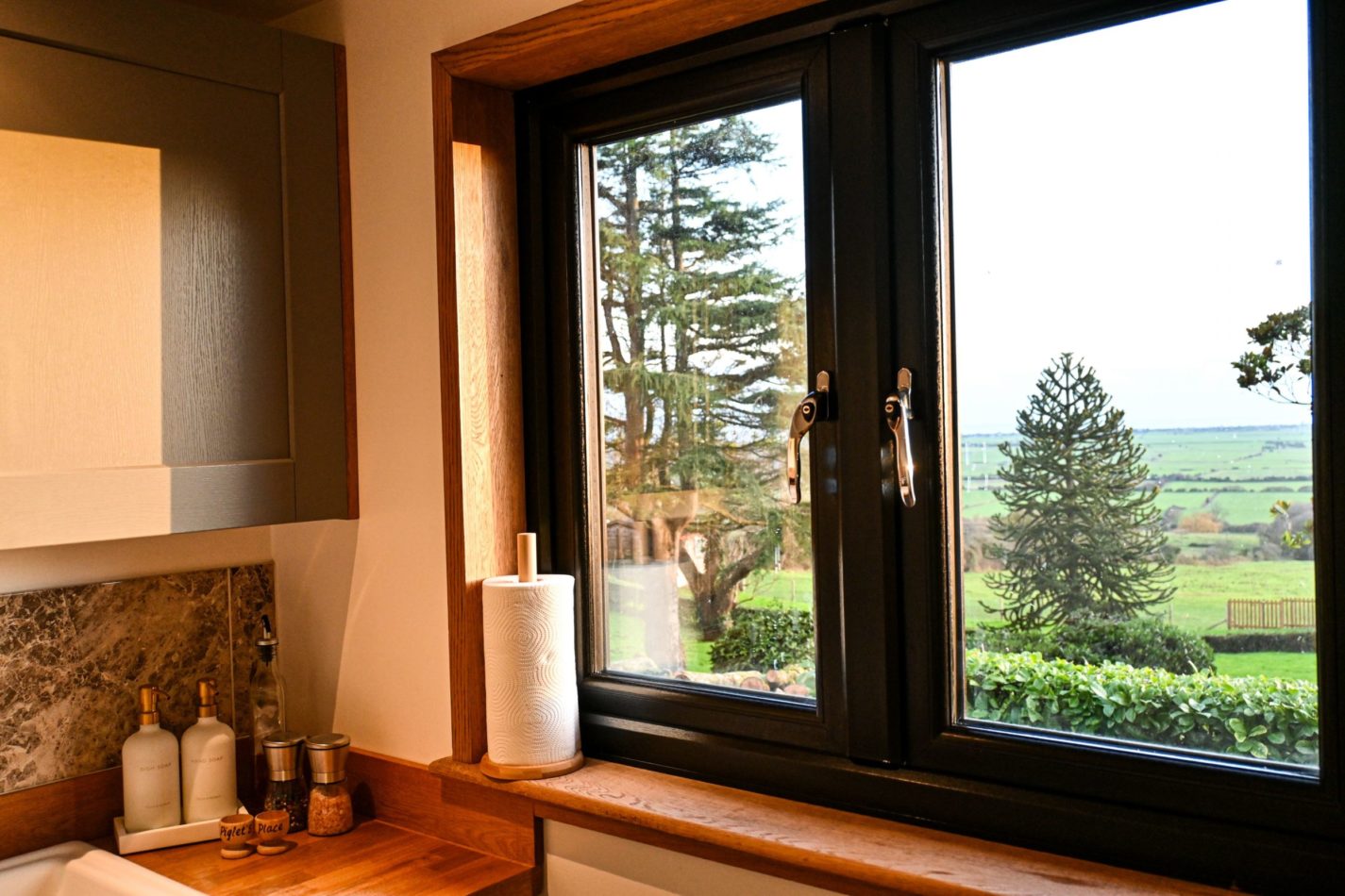 Even washing up comes with a view—look out across the trees, rolling Kent countryside and towards the sea from the kitchen window.