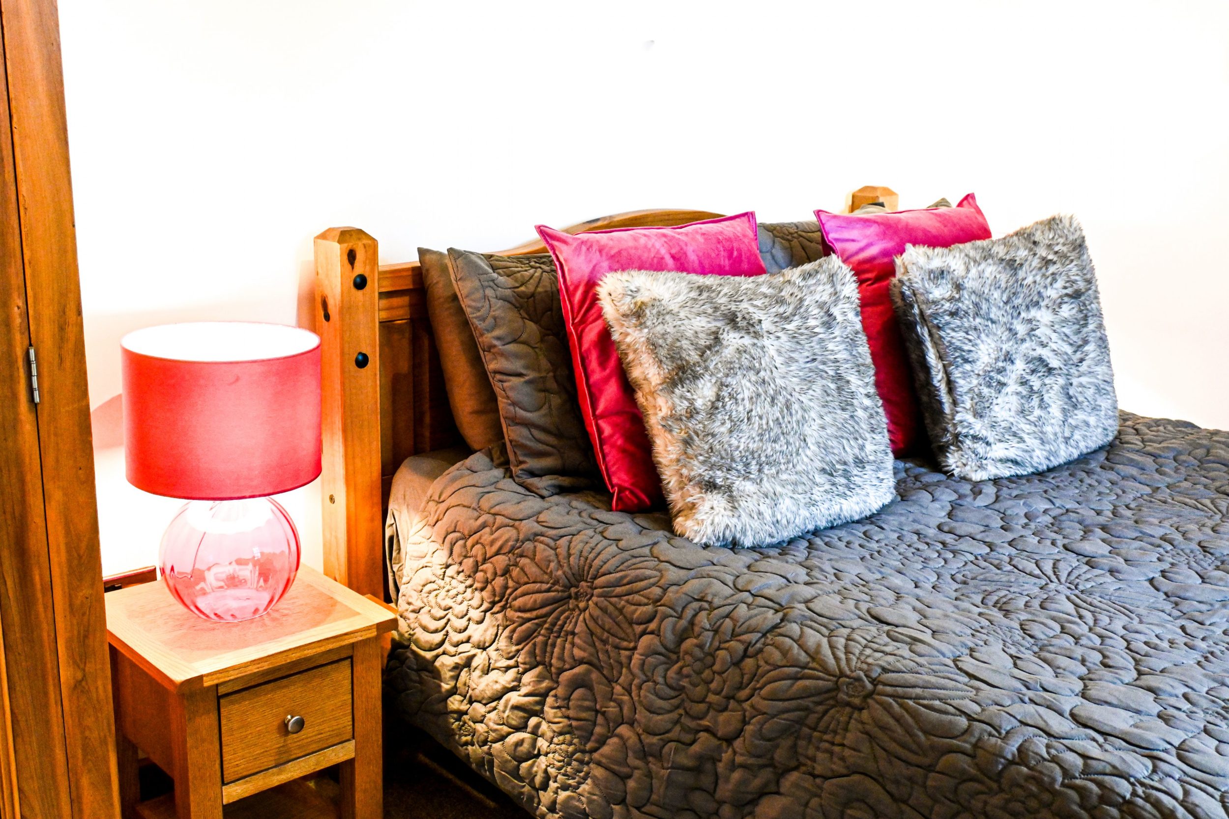 Settle into the cosy double bed, surrounded by soft velvet cushions and warm bedside lightingâ€”the perfect retreat after a day exploring Port Lympne.