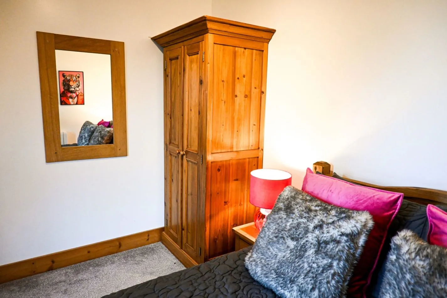 Unpack, settle in and make yourself at home—the bedroom includes generous wooden storage alongside its comfortable double bed.