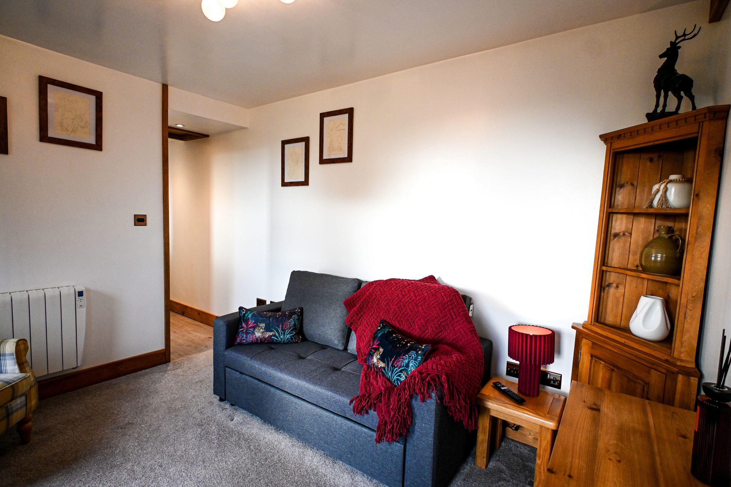 Curl up in the comfortable lounge with a warm blanket and a good filmâ€”the sofa also converts into a bed for two additional guests.