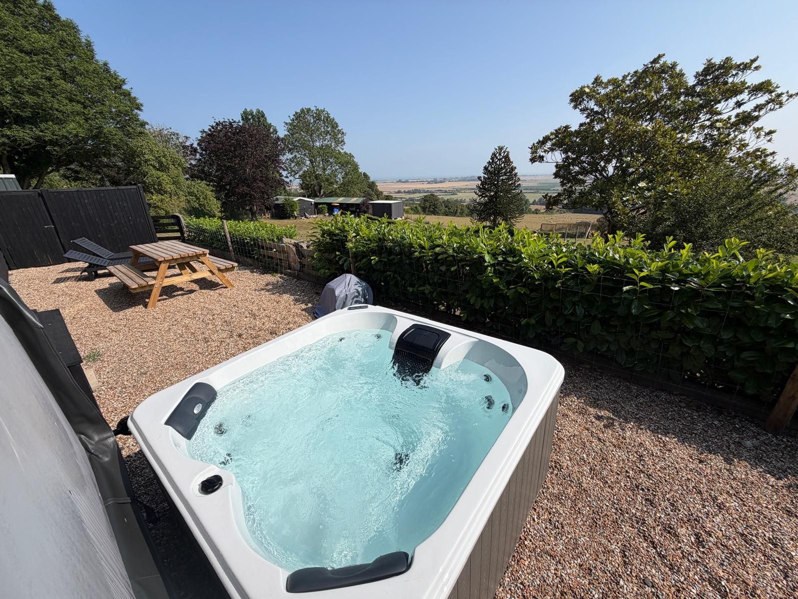Sink into your private hot tub and enjoy the bubbles while looking across the peaceful garden, surrounding countryside and distant sea.