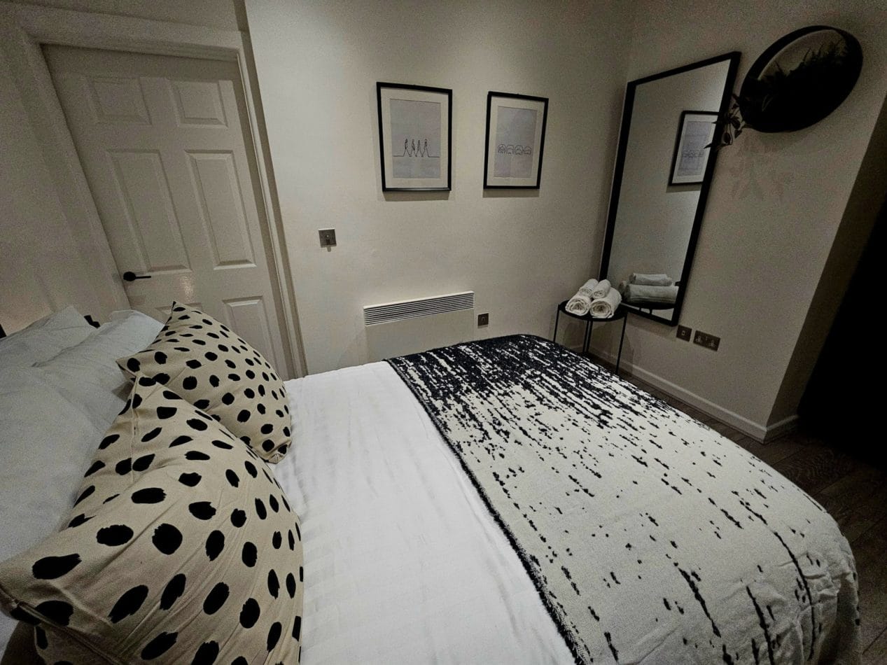 Comfortable double bedroom with storage for clothing and belongings, allowing longer-stay guests to properly unpack and settle in rather than living out of a suitcase throughout their time working in Liverpool.
