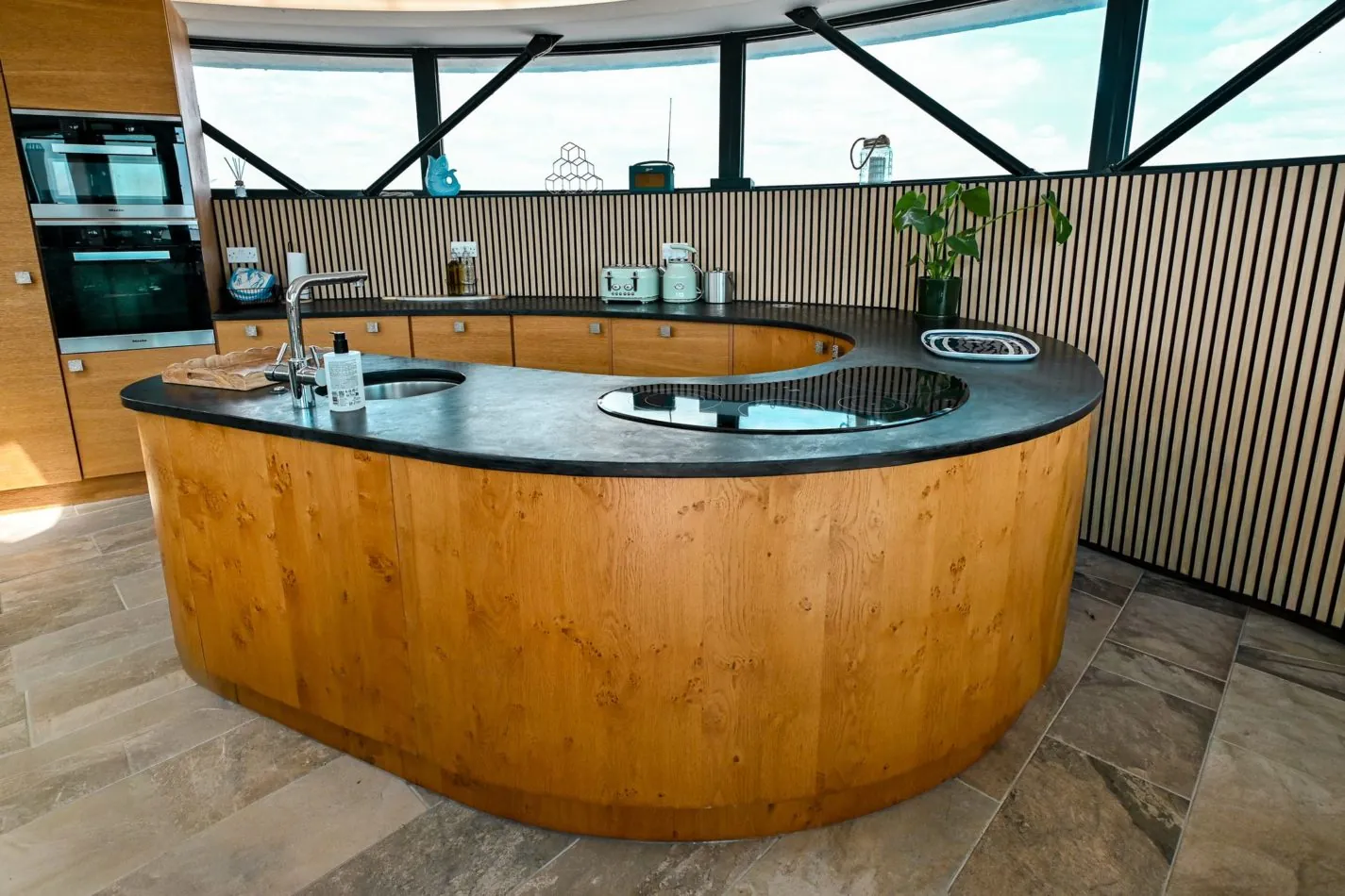 The heart of the tower! This spectacular curved kitchen island follows the shape of the building itself, creating a wonderfully sociable space for cooking, chatting and pouring that first glass of holiday wine.