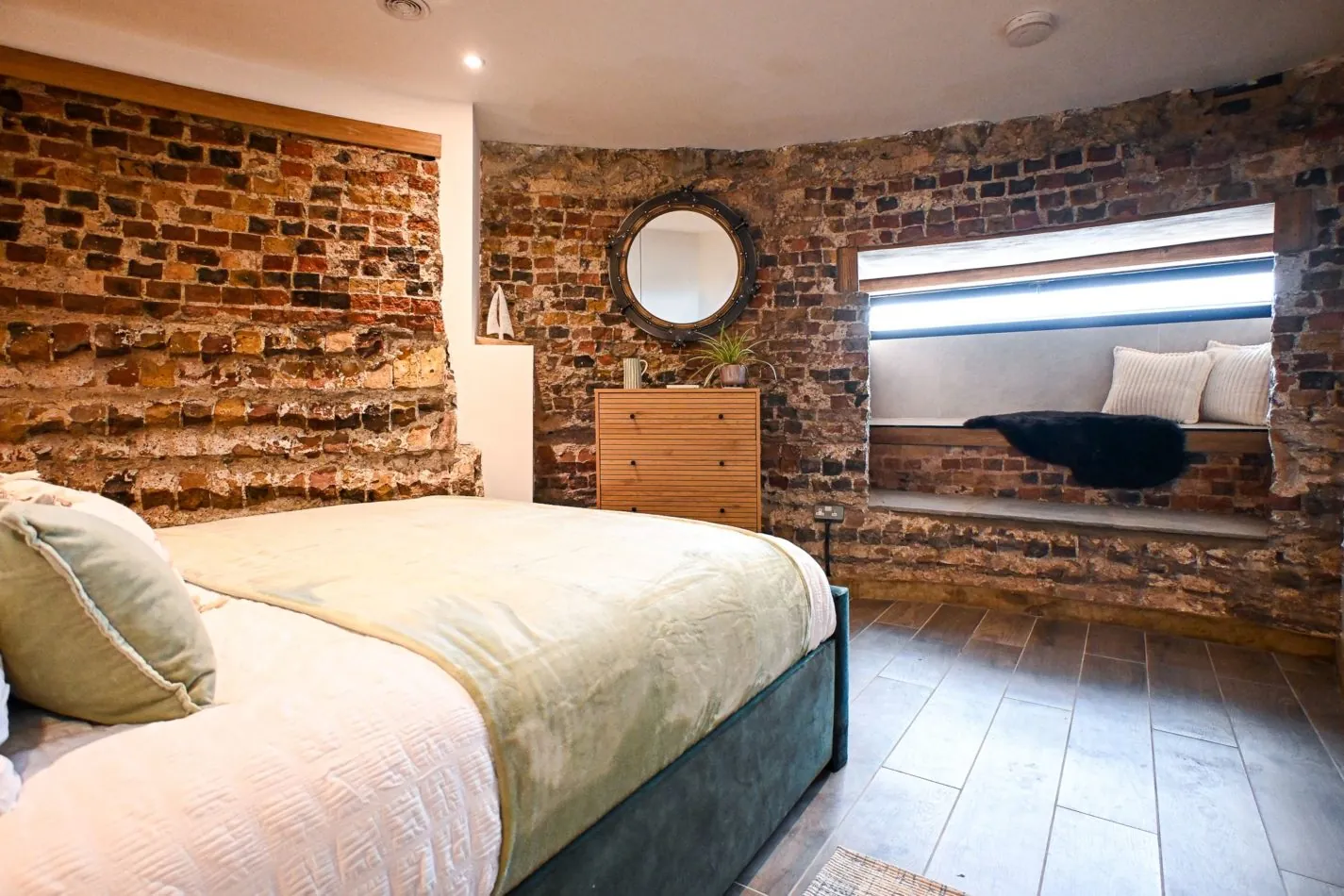 Wake up somewhere extraordinary. This beautiful king bedroom combines original exposed brick with one of the tower’s deep window seats — a little nook created by walls that have stood here for centuries.