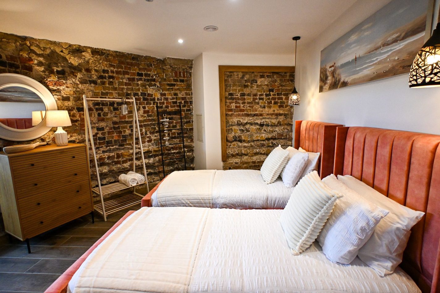 A flexible bedroom made for family getaways, with twin beds, warm exposed brick and plenty of character. A cosy retreat at the end of a day filled with sand, sea and Dymchurch adventures.
