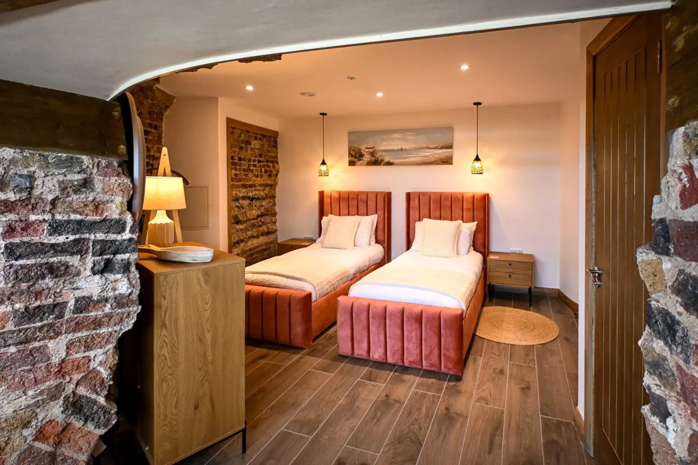 A gorgeous twin room tucked within the historic walls of the tower. Warm exposed brick, soft lighting and comfortable beds create a cosy retreat for children, friends or family after a day exploring the coast.