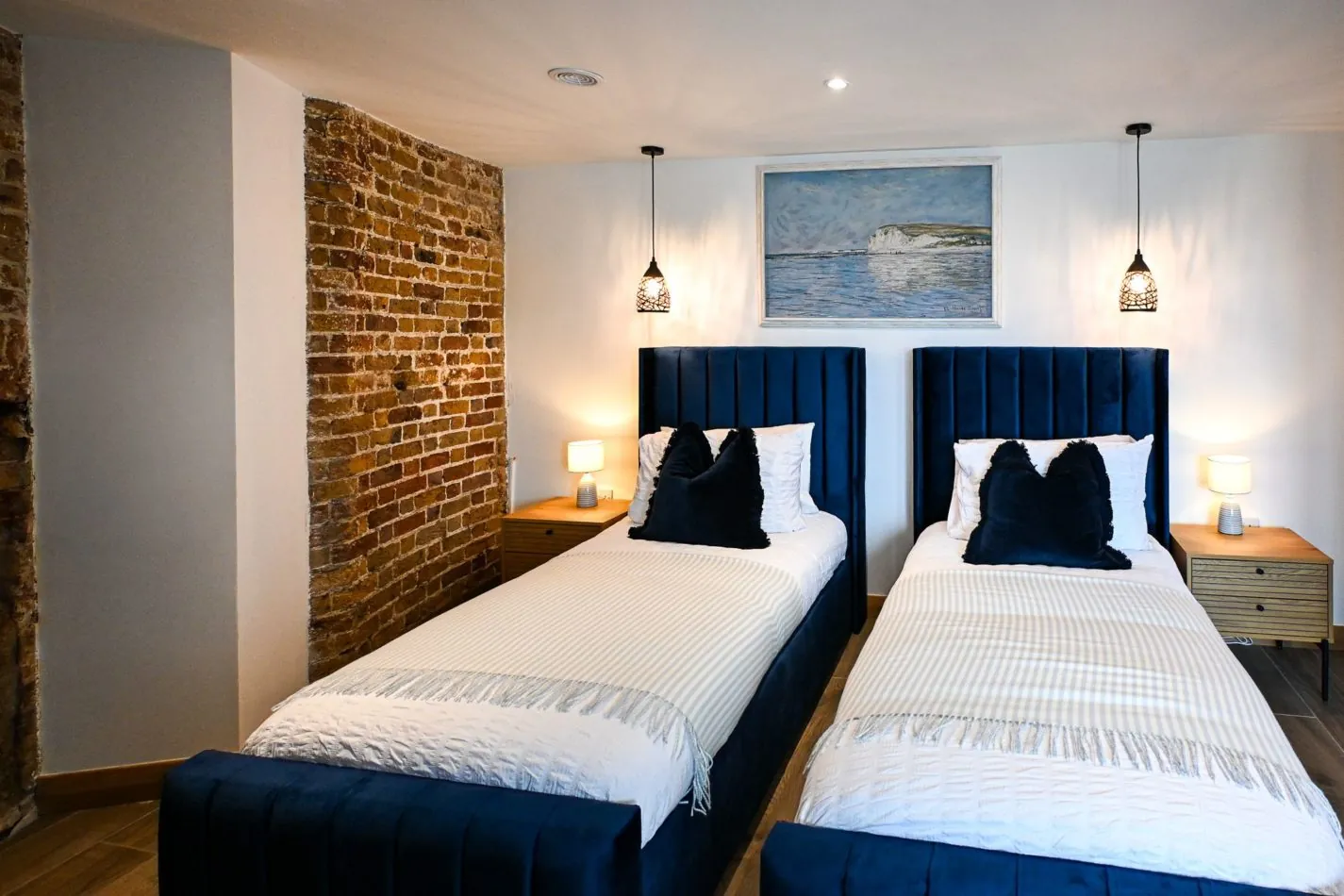 Travelling with family or friends? Flexible twin beds make sharing easy, while deep blue upholstery, exposed brick and atmospheric lighting ensure this bedroom still feels every bit as special as the rest of the tower.