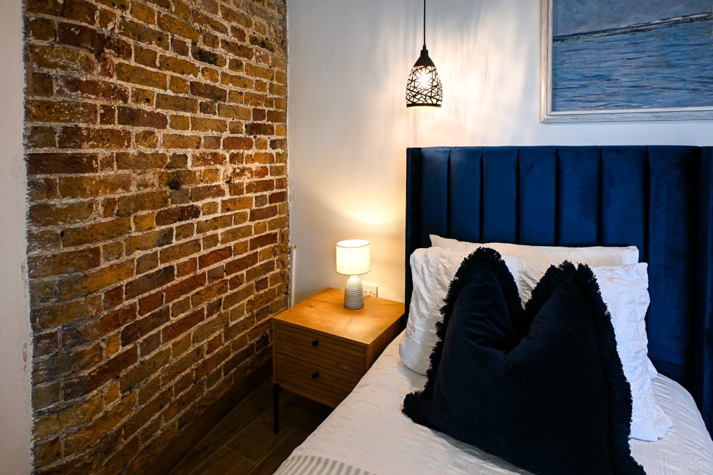 Sink into a king-size bed after a day beside the sea. Rich textures, exposed brick and carefully chosen lighting create a wonderfully cocooning bedroom inside the solid walls of this historic tower.