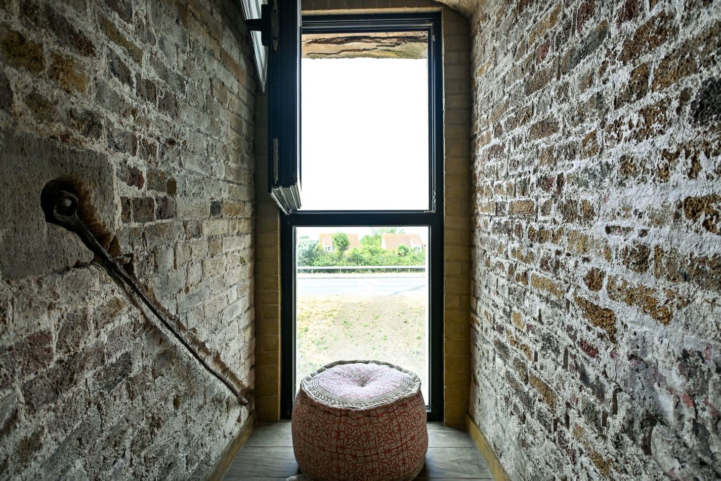 Look at the depth of those walls! This narrow window and exposed brick give you a glimpse of the tower’s original defensive architecture — historic details that make staying here an experience in itself.