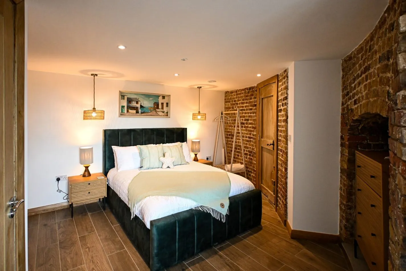 One of four beautifully designed bedrooms, where luxurious modern comfort meets the unmistakable curves and exposed brick of a historic Martello Tower. The perfect place to retreat after a day beside the sea.