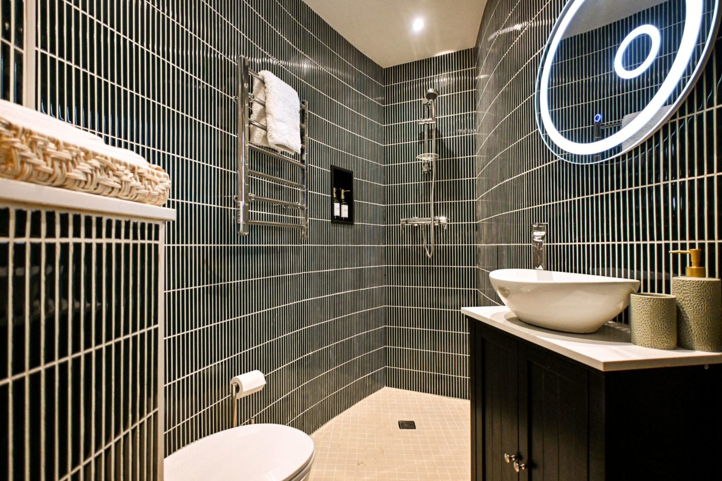 A little hotel-style luxury inside a 200-year-old fortification. Sleek dark tiling, a statement illuminated mirror and contemporary fittings make this en-suite feel wonderfully indulgent.