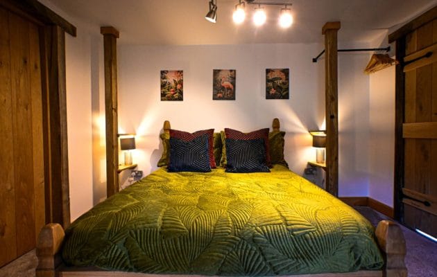 Sink into sumptuous bedding after a day exploring the Kent countryside. This inviting double bedroom combines rich, opulent colours with the cosy character of a log cabin retreat.