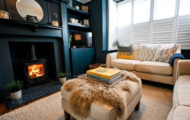 Cosy up beside the log burner after a blustery walk along Hythe seafront, with soft furnishings and comfortable seating creating a welcoming winter retreat.