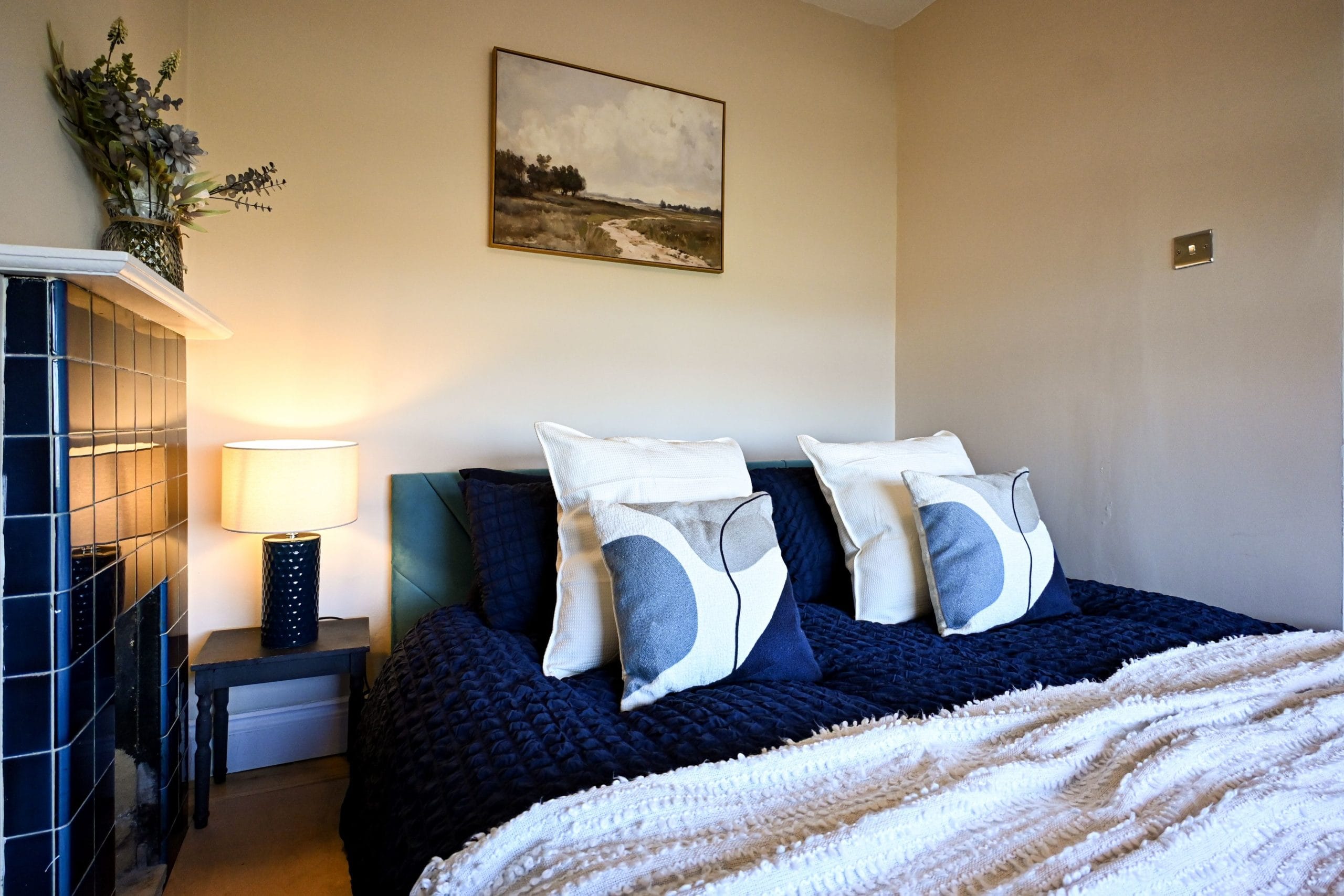 Sink into the crisp bedding and soft pillows in this inviting bedroom, with warm bedside lighting and calming neutral tones to help you switch off and enjoy a restful night.