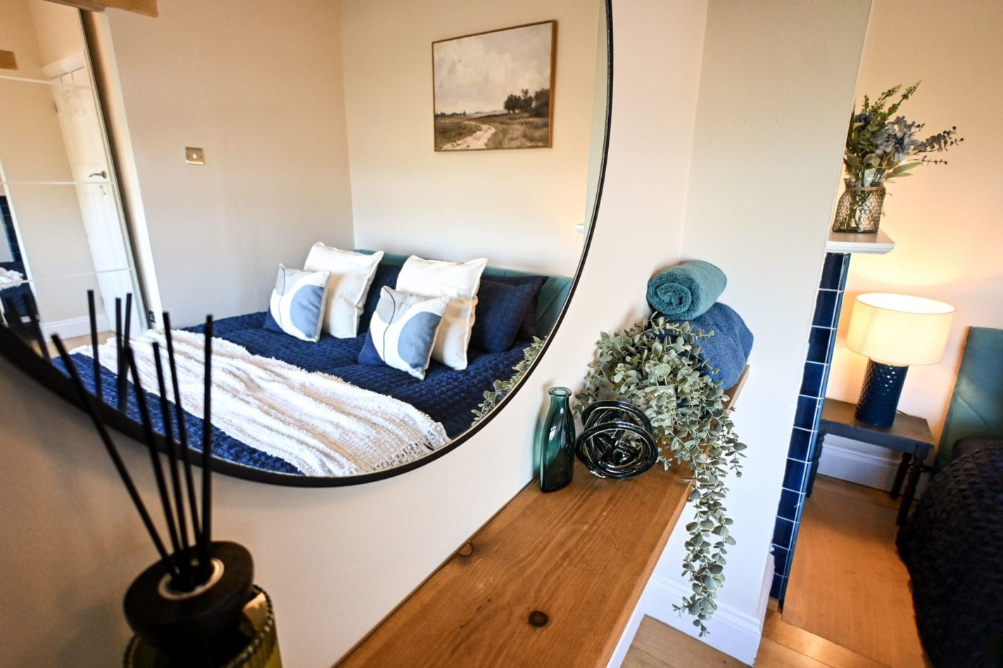 Thoughtful finishing touches make this bedroom feel extra welcoming, with a stylish mirror, carefully chosen accessories and a cosy bed waiting at the end of a busy day.