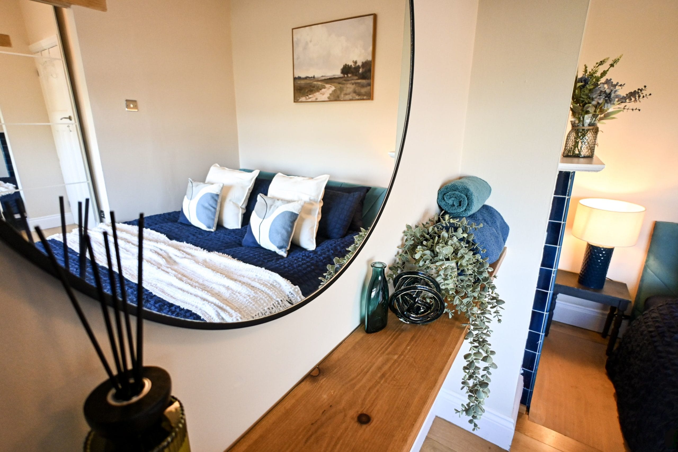 Thoughtful finishing touches make this bedroom feel extra welcoming, with a stylish mirror, carefully chosen accessories and a cosy bed waiting at the end of a busy day.