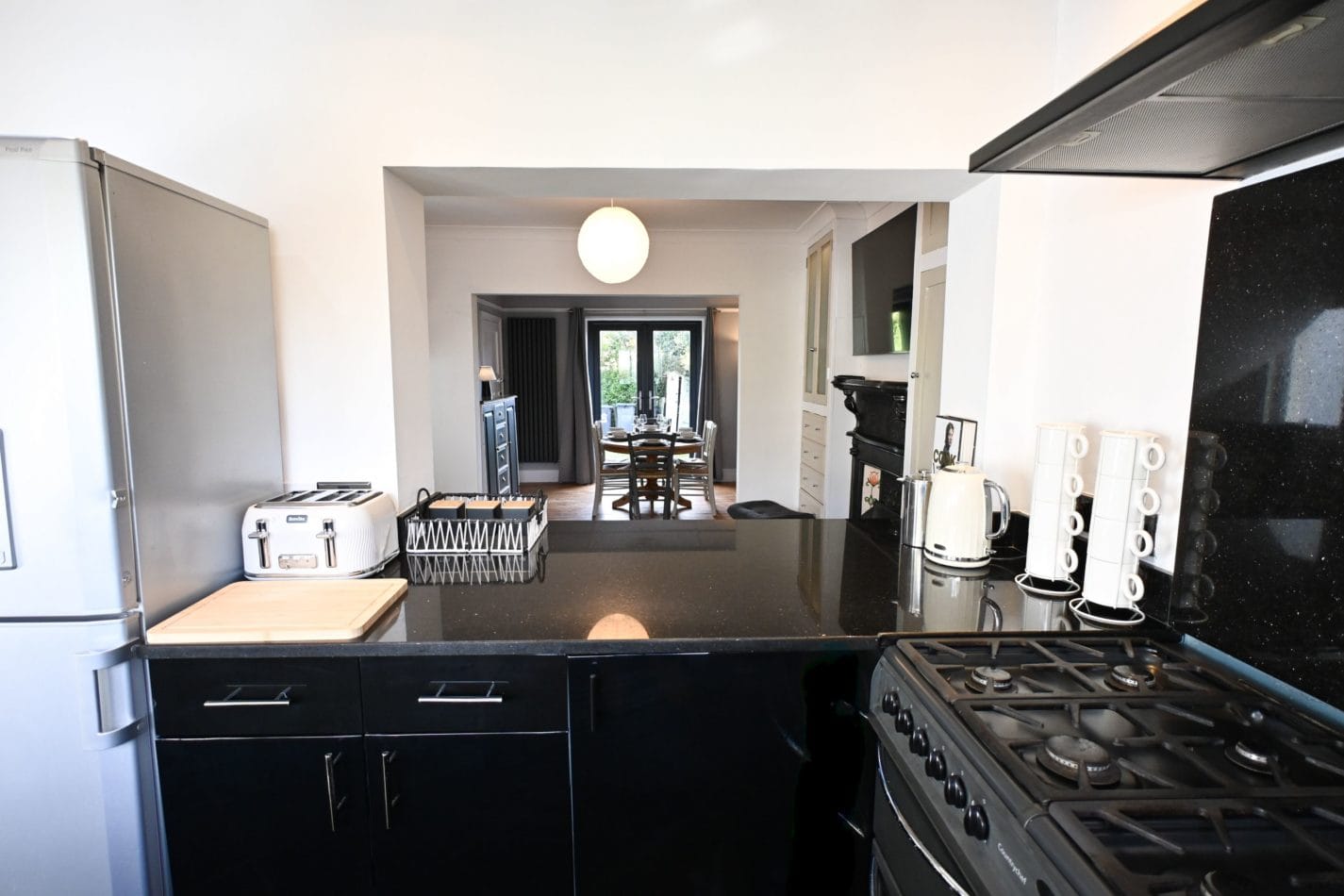 The kitchen connects beautifully with the living and dining spaces, making it easy to prepare a family meal while still enjoying the company of everyone relaxing nearby.