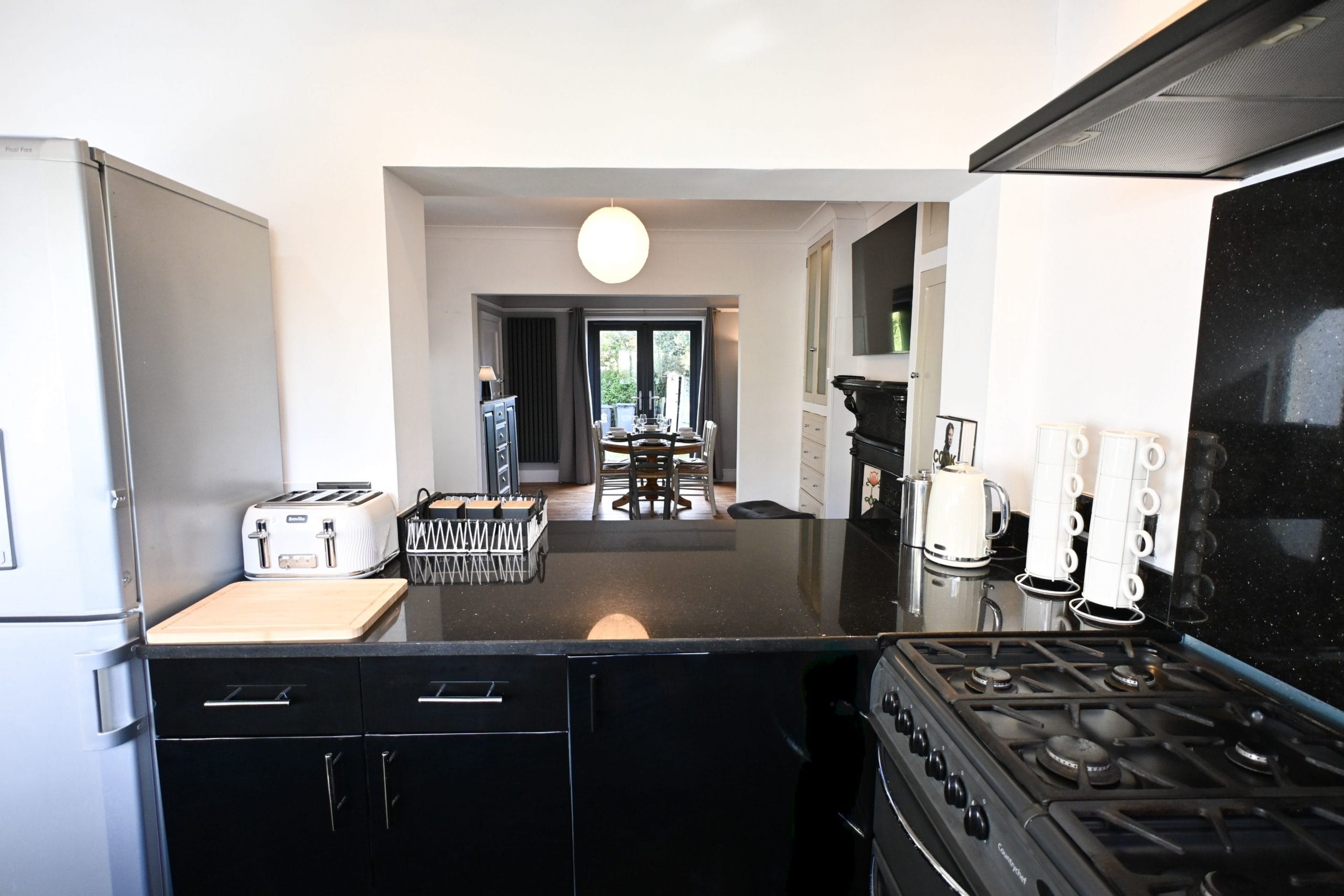 The kitchen connects beautifully with the living and dining spaces, making it easy to prepare a family meal while still enjoying the company of everyone relaxing nearby.