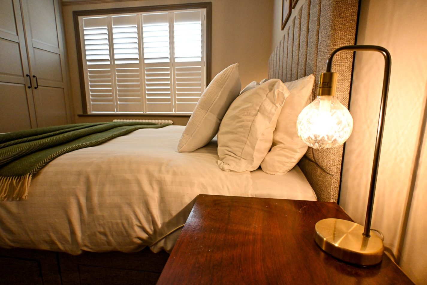 Sink into the beautifully dressed king size bed, with soft bedding, warm bedside lighting and elegant details creating the perfect setting for a restful night.